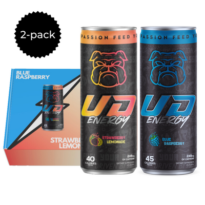A promotional graphic presenting a 2-pack of UD Energy performance drinks, featuring one can each of Strawberry Lemonade and Blue Raspberry flavors. The cans are front and center with bold bulldog logos and vibrant design accents, alongside a badge indicating the pack size and a background with color gradients matching each flavor.